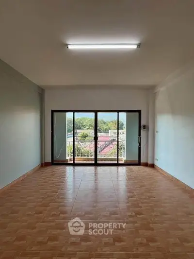Spacious empty room with large windows and scenic view, perfect for customization.