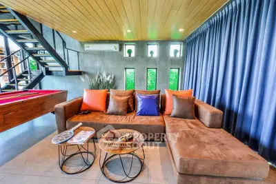 Modern living room with stylish sectional sofa and vibrant decor in a contemporary home.