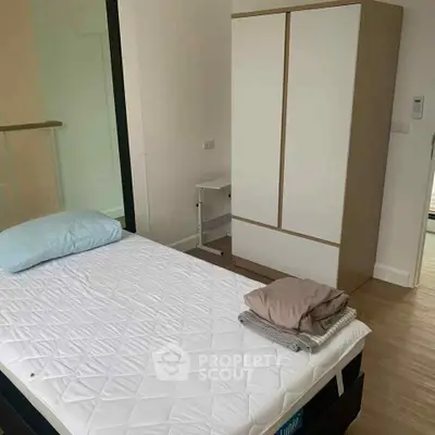 Cozy bedroom with modern wardrobe and comfortable bed in a bright apartment.