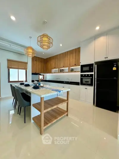 Modern kitchen with island, sleek cabinetry, and stylish lighting in a contemporary home.