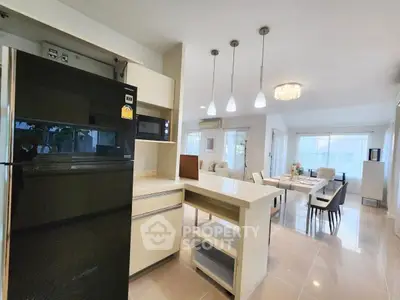 Spacious open-plan kitchen and living area with modern appliances and elegant lighting.