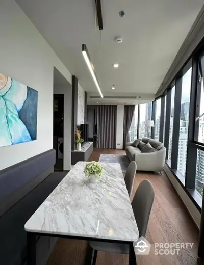 Modern living room with panoramic city views and elegant marble dining table.