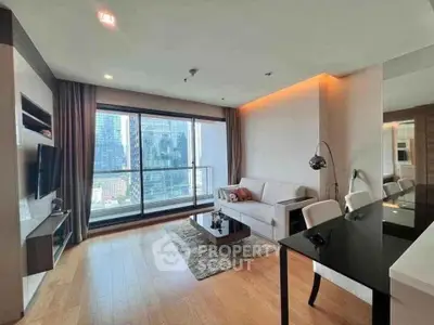 Modern living room with city view, sleek furniture, and wooden flooring in a high-rise apartment.