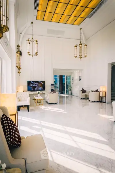Luxurious living room with high ceilings and elegant chandeliers