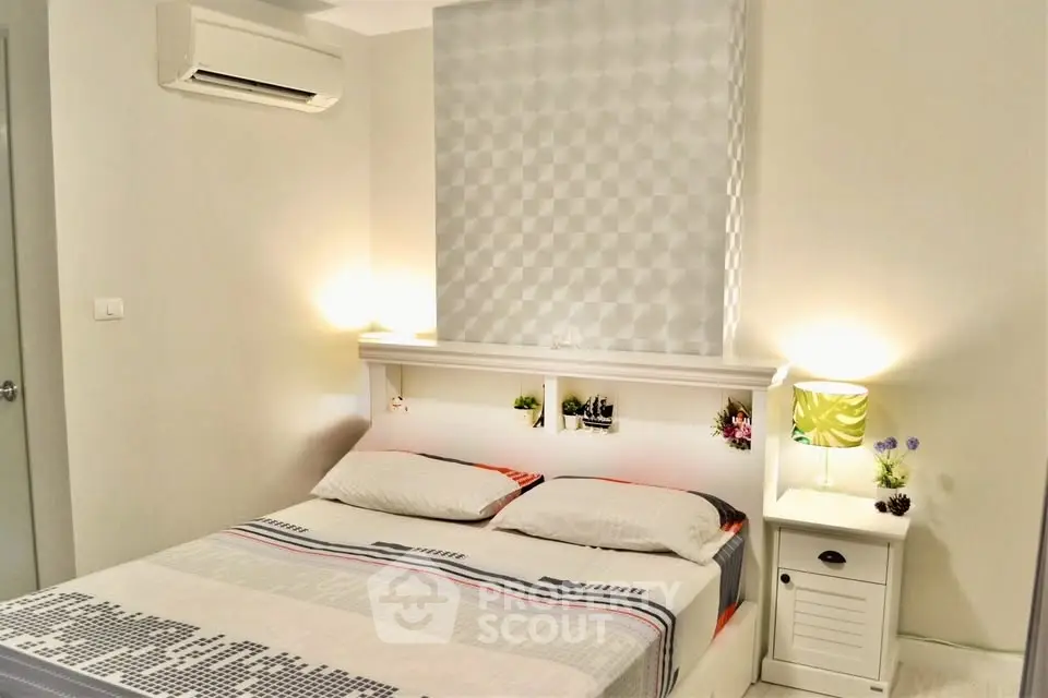 Cozy bedroom with modern decor and ambient lighting, featuring a stylish air conditioning unit.