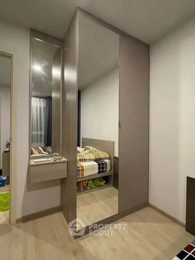 Modern bedroom with mirrored wardrobe and cozy decor