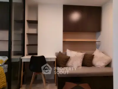 Cozy study nook with built-in shelves and modern chair in stylish apartment