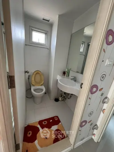Compact bathroom with modern fixtures and colorful decor