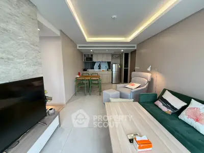 Modern living room with open kitchen layout and stylish furniture