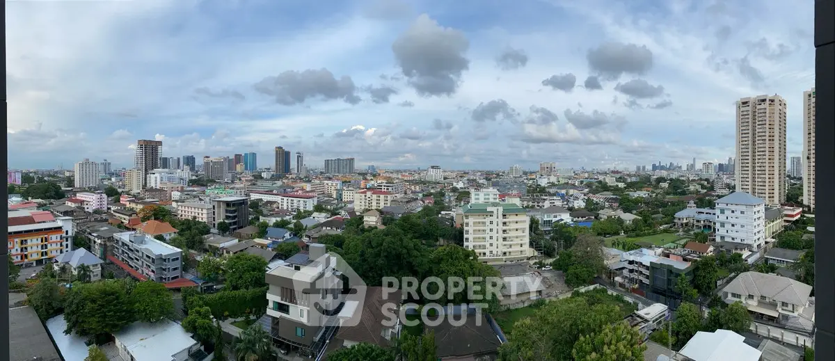 Panoramic cityscape view showcasing urban skyline and residential buildings.