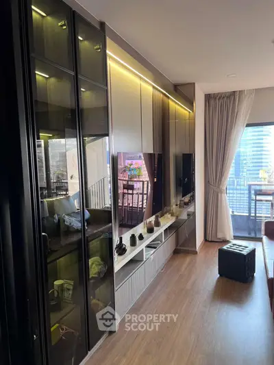 Modern living room with sleek storage and balcony view