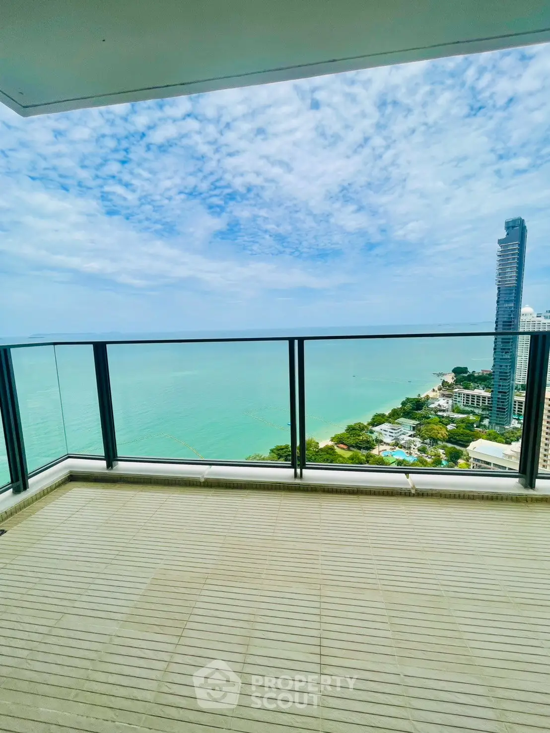 Stunning ocean view from a spacious balcony in a high-rise building, perfect for relaxation and enjoying the scenery.