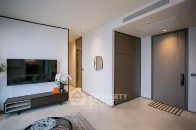 Modern living room with sleek design and large TV, perfect for relaxation.