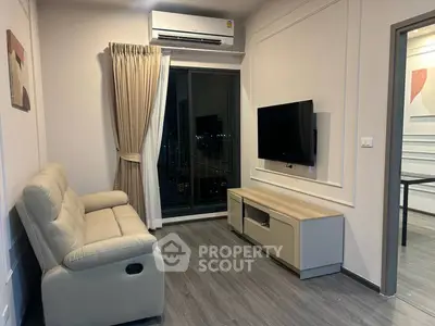 Modern living room with sleek furniture and city view from balcony, perfect for urban living.