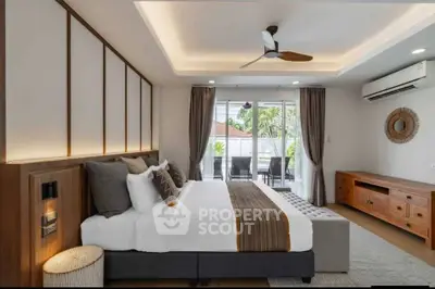 Luxurious bedroom with modern decor and balcony access in a stylish home.