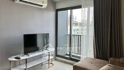 Modern living room with balcony view, featuring sleek TV stand and air conditioning.