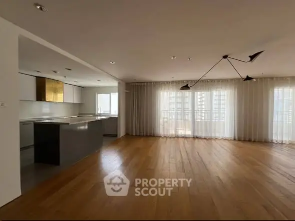 Spacious modern living room with open kitchen and large windows