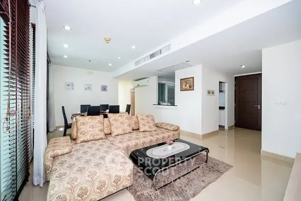 Spacious living room with elegant decor and dining area in modern apartment.