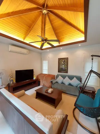 Charming living room with wooden ceiling and cozy seating area