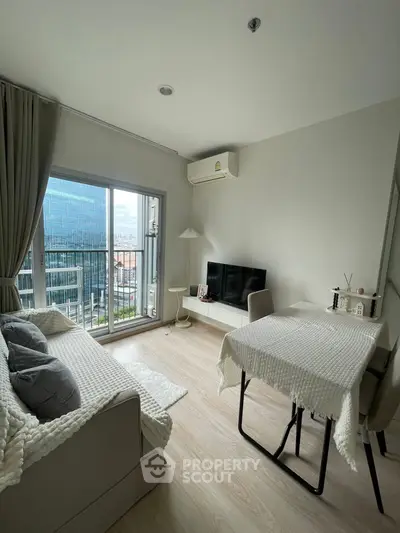 Modern living room with city view, cozy sofa, and dining area
