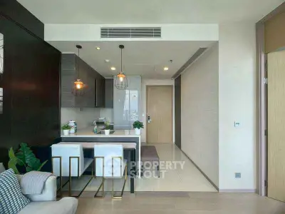 Modern open-layout kitchen with stylish lighting and breakfast bar seating