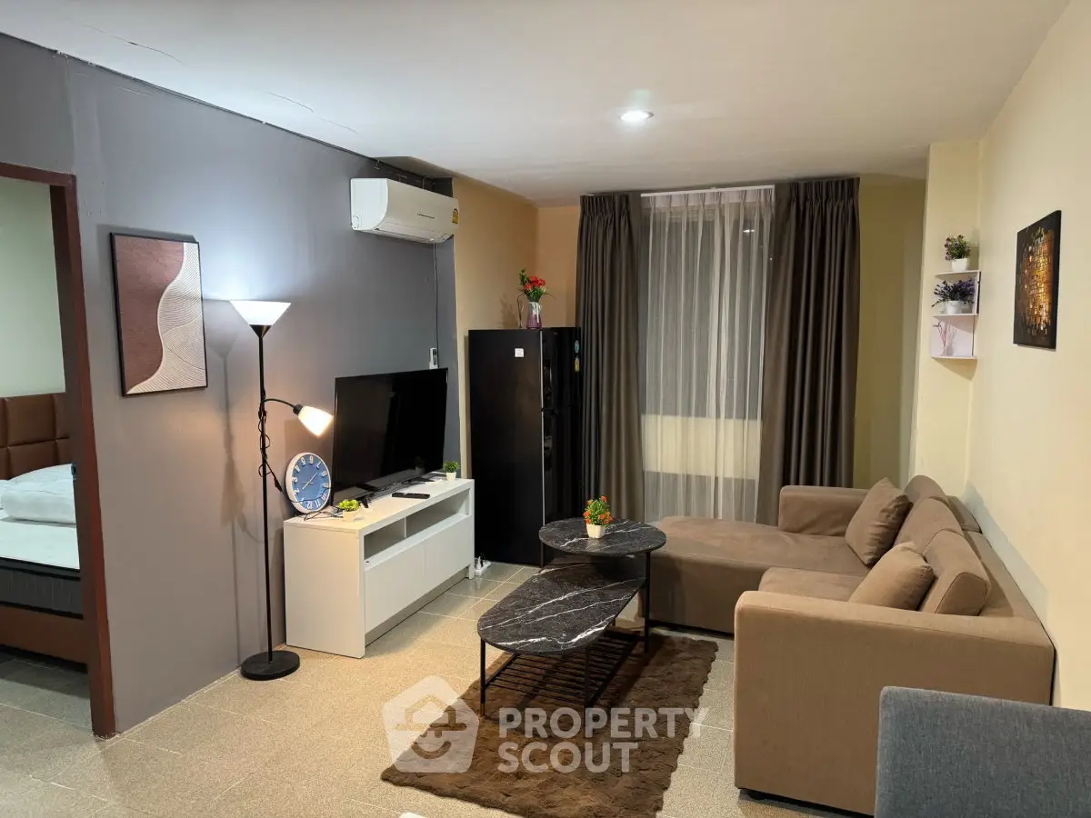 Modern living room with cozy sofa, TV, and stylish decor in a contemporary apartment.