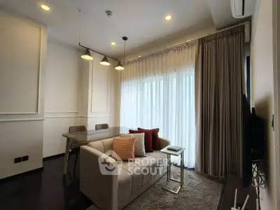 Modern living room with elegant sofa, dining table, and ambient lighting.