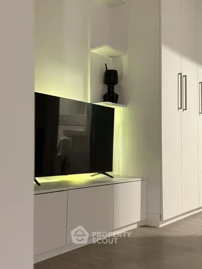 Modern living room with sleek TV unit and ambient lighting