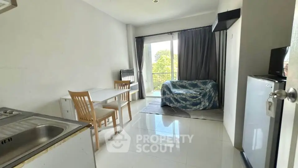 Bright living room with balcony and modern furnishings in a cozy apartment.