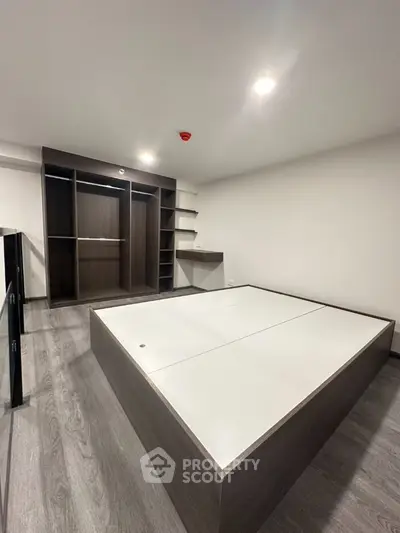 Modern bedroom with built-in wardrobe and sleek flooring