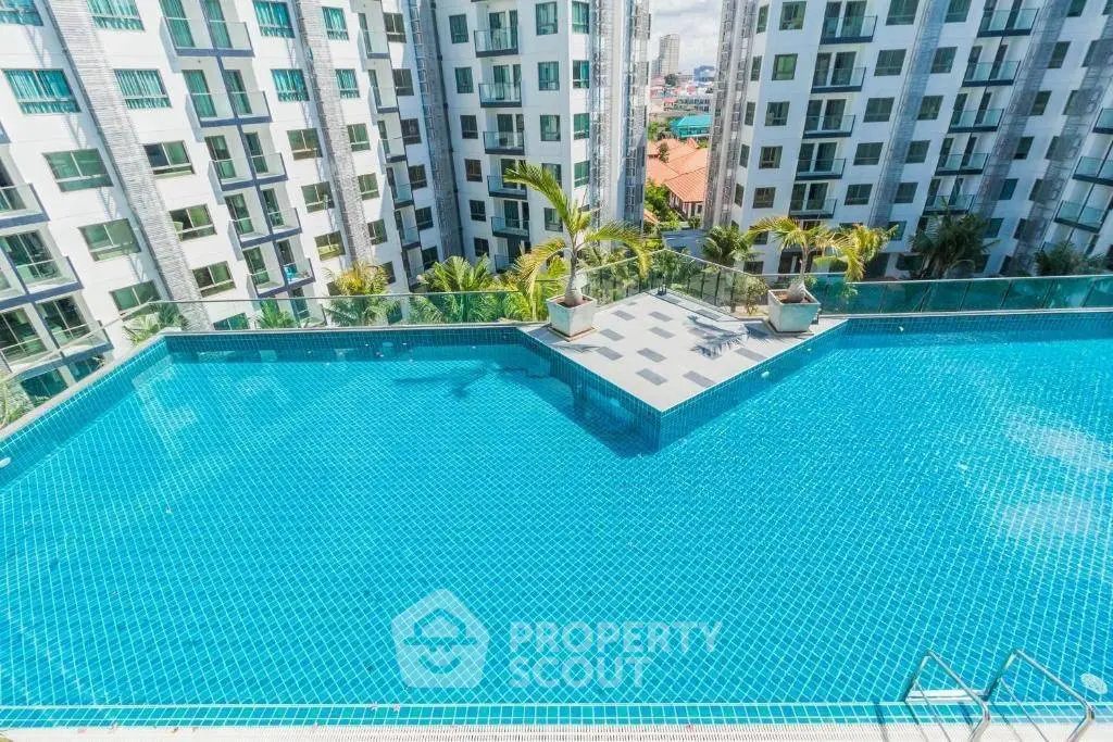 Luxurious rooftop infinity pool with stunning cityscape views in modern high-rise complex.