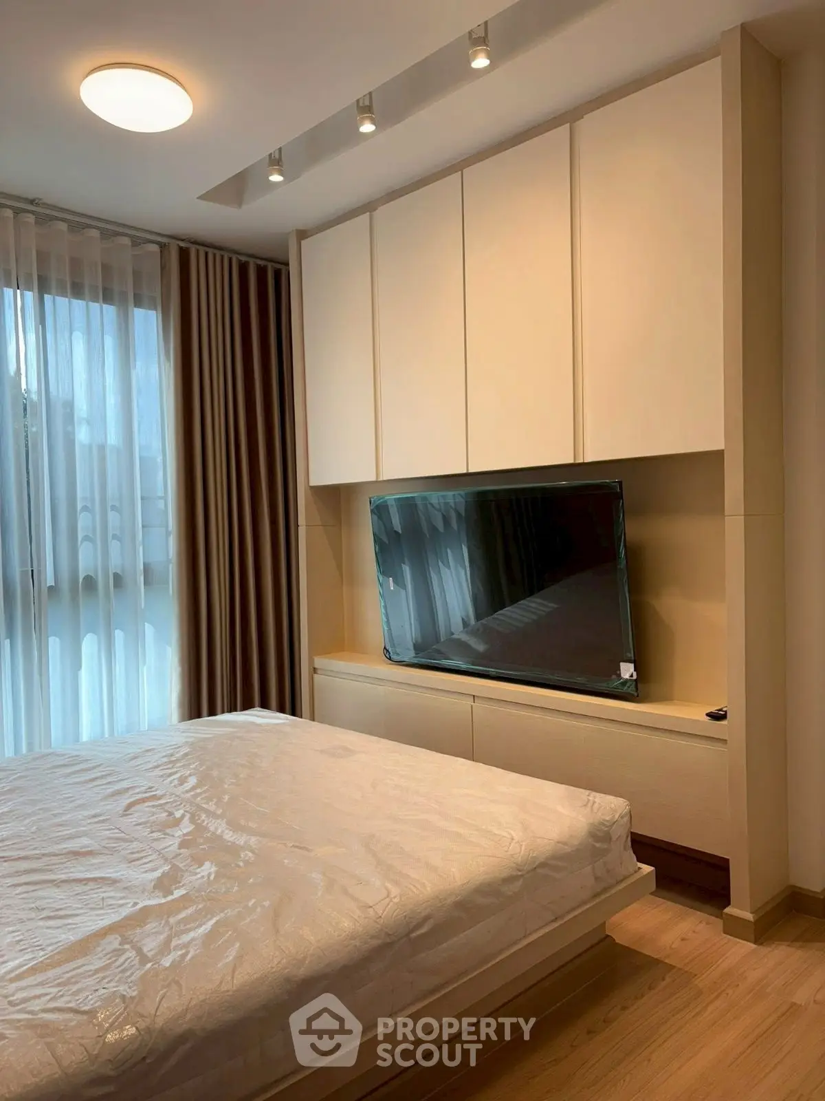 Modern bedroom with sleek design and large window for natural light