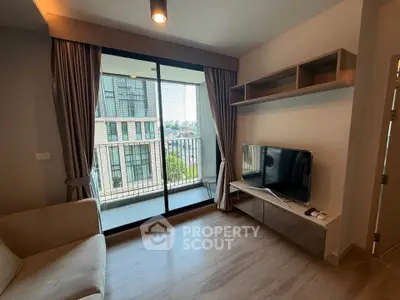 Modern living room with balcony view, sleek TV setup, and elegant curtains.