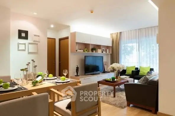 Modern living room with stylish decor and dining area, featuring natural light and contemporary furniture.