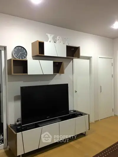 Modern living room with sleek TV unit and stylish wall shelves