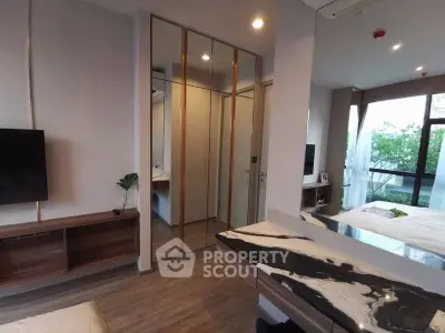 Modern bedroom with sleek design, large windows, and stylish furniture in a contemporary apartment.