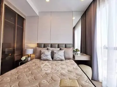 Luxurious bedroom with elegant decor and large windows offering natural light.