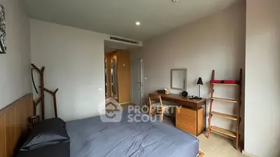 Spacious bedroom with modern furniture and natural light