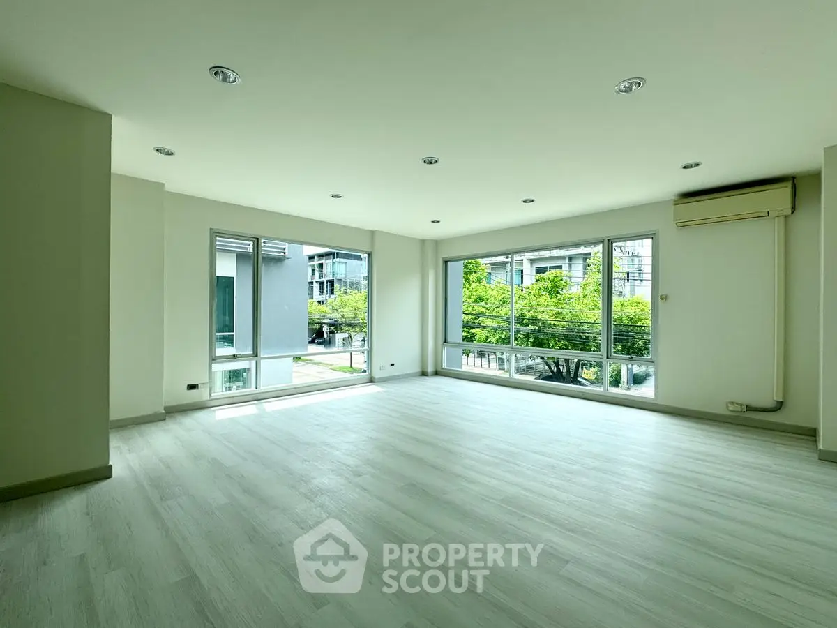 Spacious corner unit living room with large windows and abundant natural light