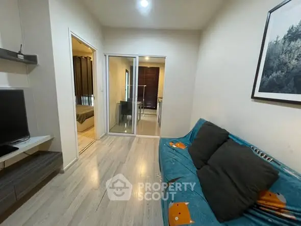 Cozy living room with modern decor and adjacent bedroom view