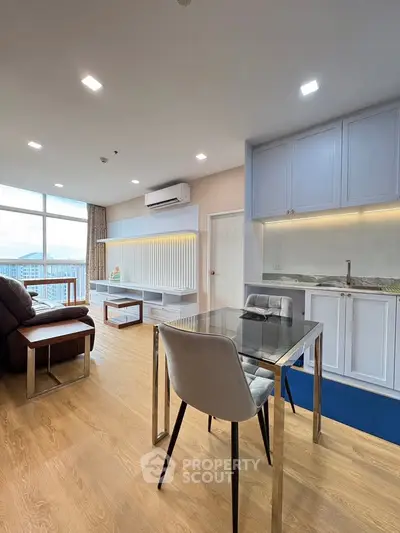 Modern living room with sleek furniture and large windows offering stunning views.