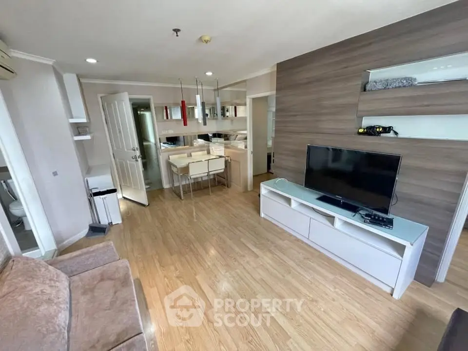 Modern living room with open kitchen and stylish wooden flooring