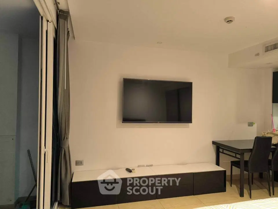 Modern living room with wall-mounted TV and sleek furniture