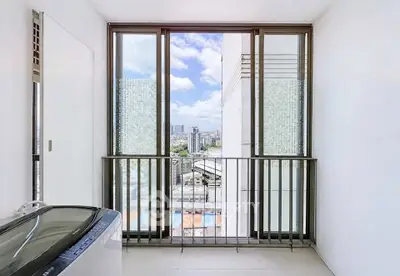 Modern balcony with city view and washing machine, perfect for urban living.
