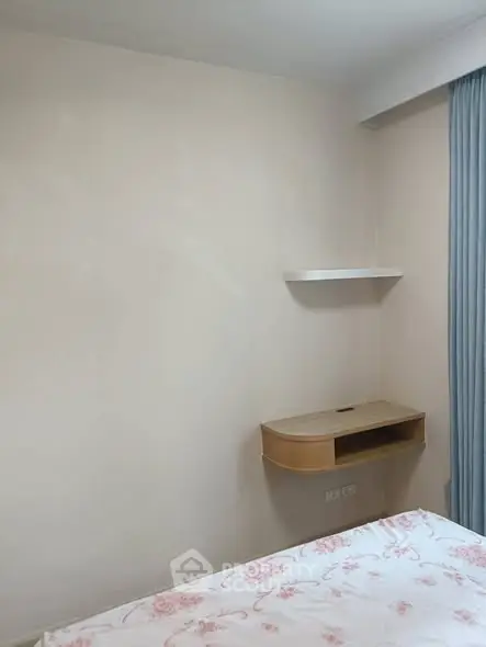 Cozy bedroom corner with minimalist shelf and soft curtains