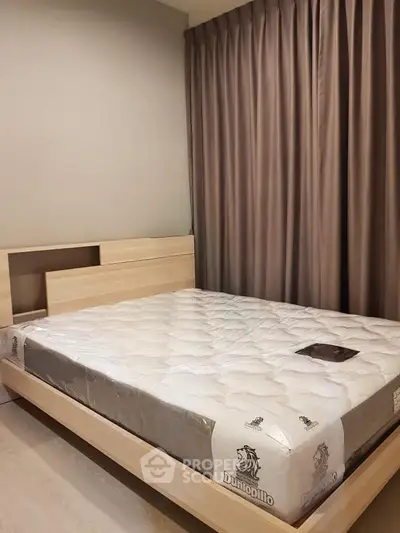 Modern bedroom with stylish wooden bed frame and plush mattress, complemented by elegant floor-to-ceiling curtains.