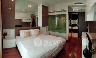 Luxurious bedroom with modern design and ensuite bathroom in upscale apartment.