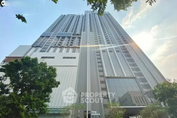 Stunning high-rise building with modern architecture and lush greenery, perfect for urban living.
