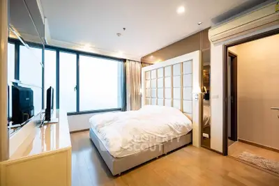 Luxurious modern bedroom with large window and stylish decor