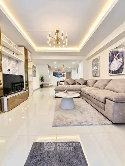 Luxurious living room with elegant chandelier and spacious seating area, perfect for modern living.